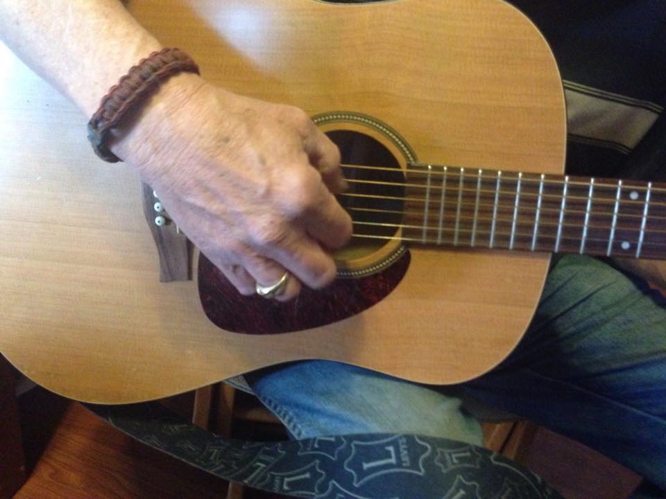 Dan playing guitar... close up of hand